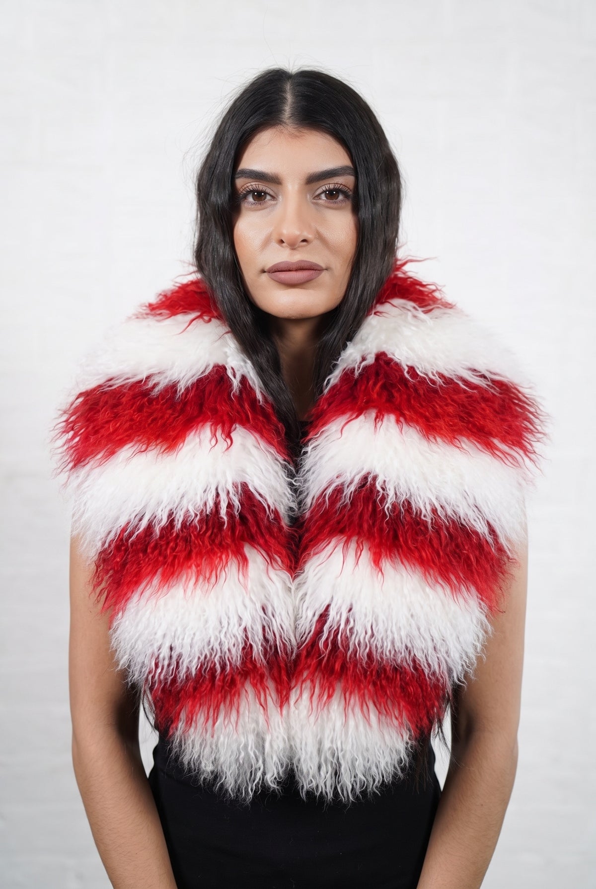 Mongolian Sheepskin Collar Red White — Curly Lamb Fur, Xmas Edition worn by a woman, front view of the long curly candy-cane red and white striped Tibetan lamb fur framing the face and shoulders, TatiFurs
