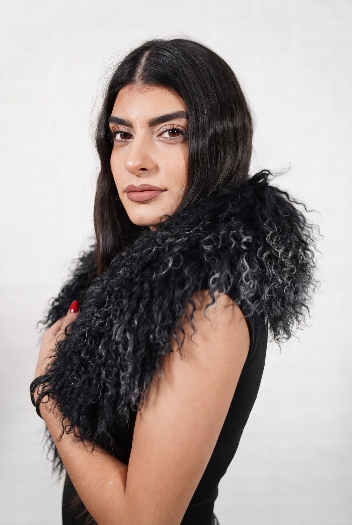 Mongolian Sheepskin Collar Black — Curly Lamb Fur three-quarter view over the shoulder, volume of the deep jet black Mongolian lamb curls around the neck — handmade in Greece, TatiFurs