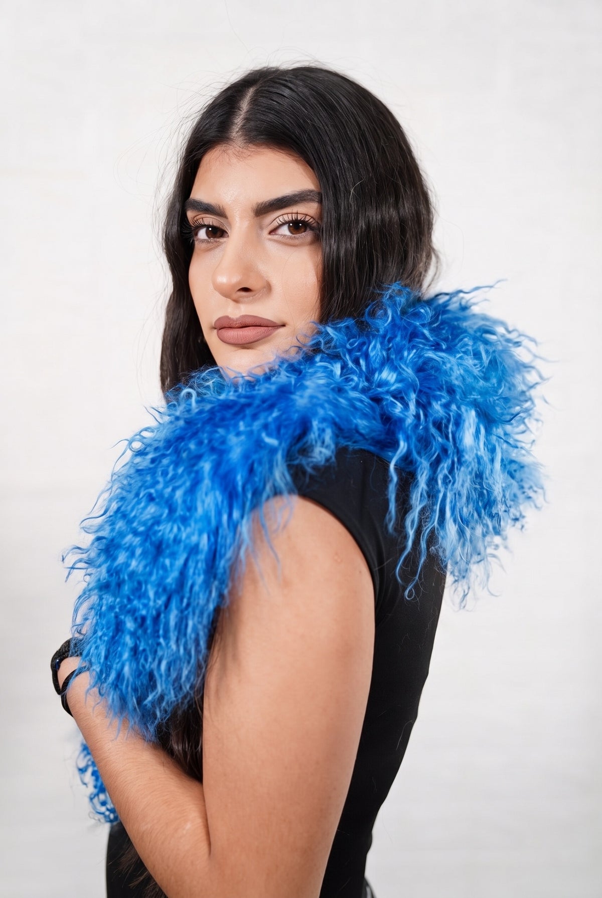 Mongolian Sheepskin Collar Blue — Curly Lamb Fur three-quarter view over the shoulder, volume of the rich cobalt blue Mongolian lamb curls around the neck — handmade in Greece, TatiFurs