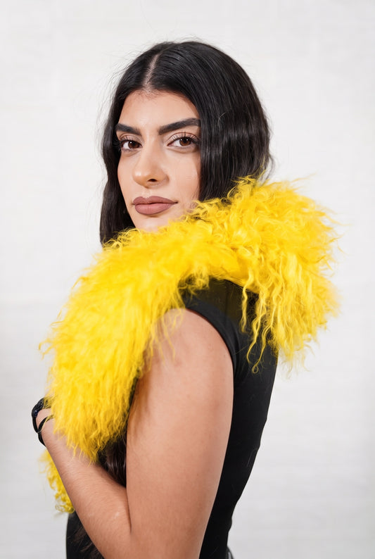 Mongolian Sheepskin Collar Yellow — Curly Lamb Fur three-quarter view over the shoulder, volume of the warm sunflower yellow Mongolian lamb curls around the neck — handmade in Greece, TatiFurs