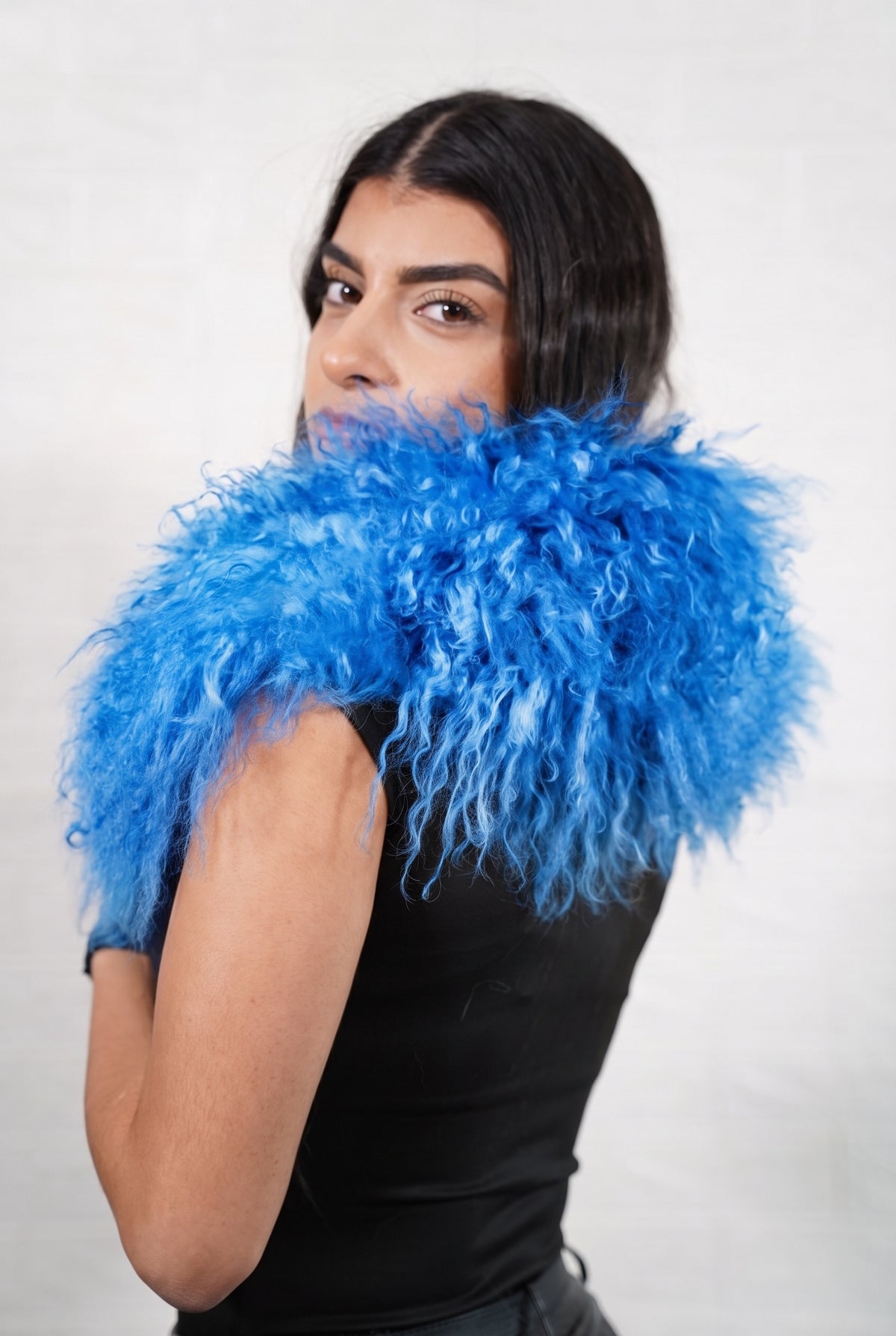 Mongolian Sheepskin Collar Blue — Curly Lamb Fur seen from behind, rich cobalt blue curly sheepskin wrapped high around the neck and shoulders — TatiFurs