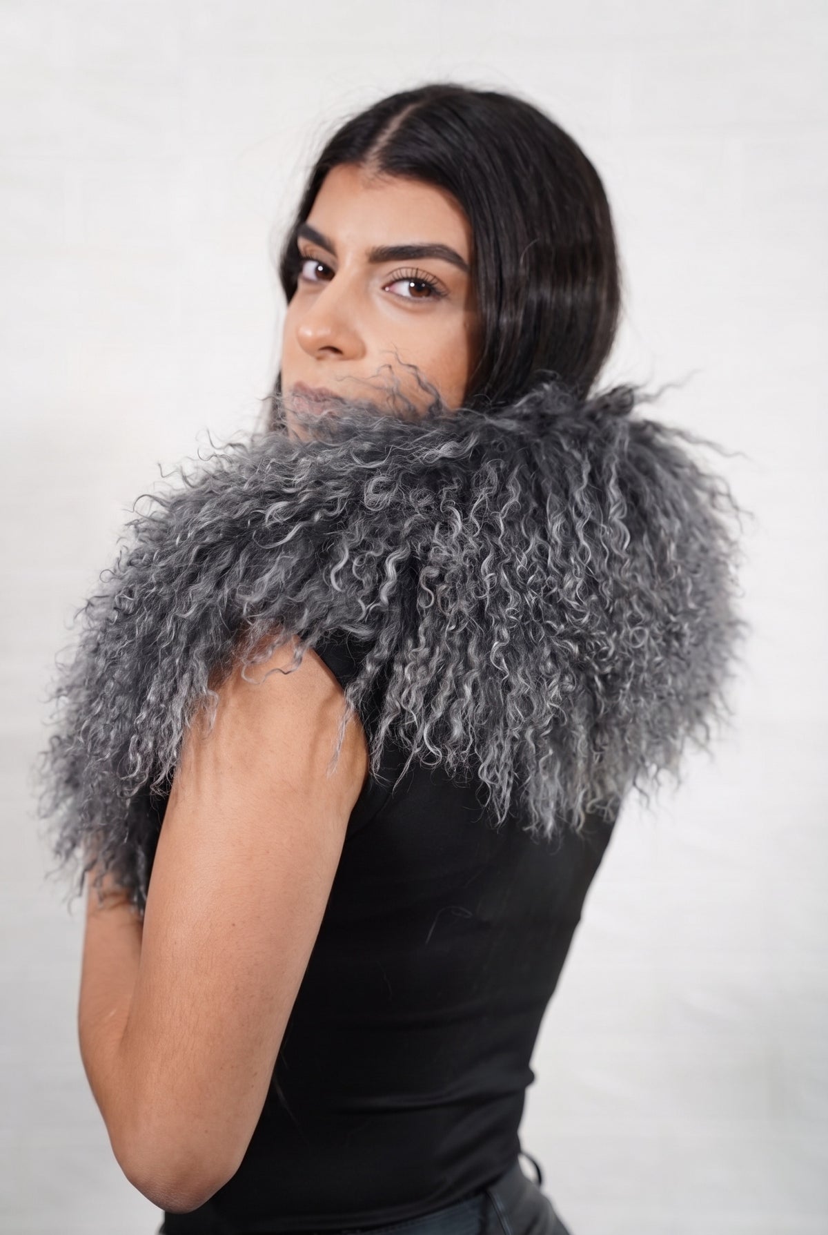 Mongolian Sheepskin Collar Grey — Curly Lamb Fur seen from behind, smoky charcoal grey curly sheepskin wrapped high around the neck and shoulders — TatiFurs