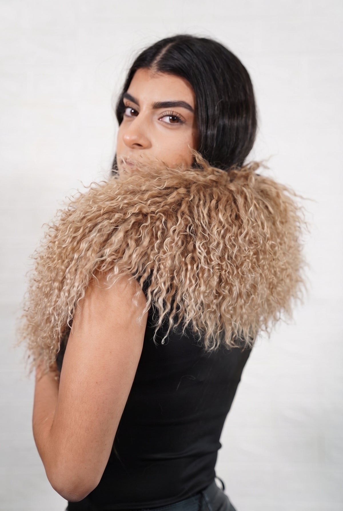Mongolian Sheepskin Collar Light Brown — Curly Lamb Fur seen from behind, milky caramel light brown curly sheepskin wrapped high around the neck and shoulders — TatiFurs