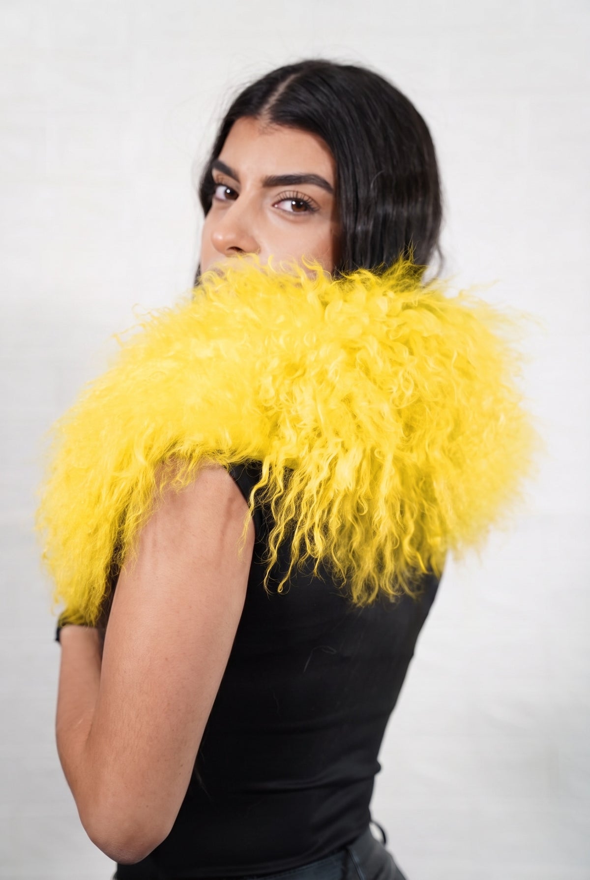 Mongolian Sheepskin Collar Yellow — Curly Lamb Fur seen from behind, warm sunflower yellow curly sheepskin wrapped high around the neck and shoulders — TatiFurs