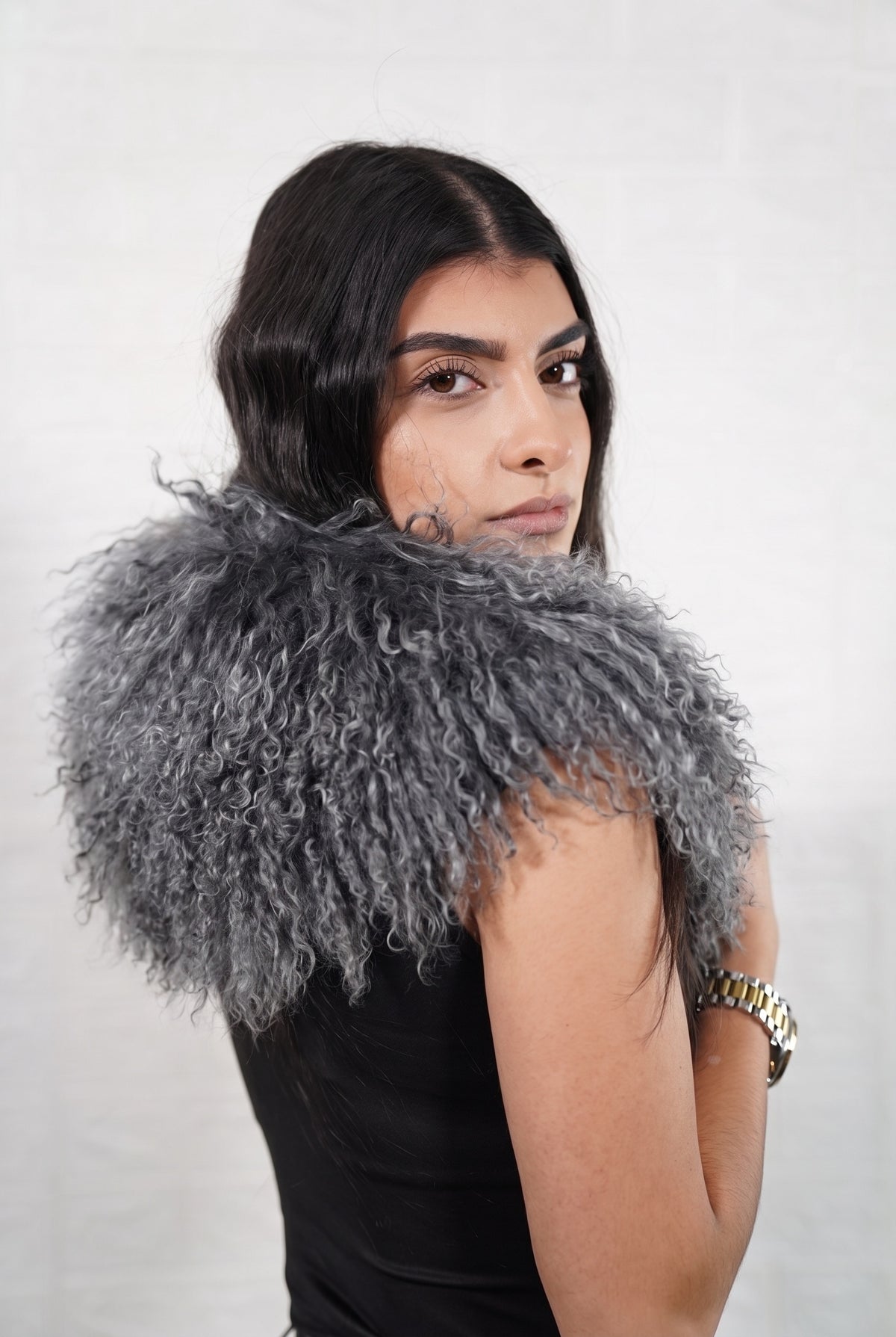 Mongolian Sheepskin Collar Grey — Curly Lamb Fur side view showing the length of the smoky charcoal grey Mongolian sheepskin collar over the shoulder — Greek craftsmanship, TatiFurs