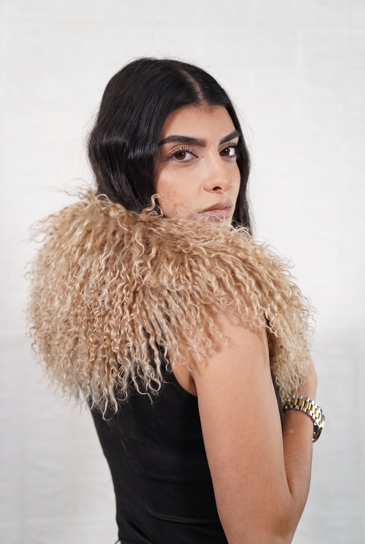 Mongolian Sheepskin Collar Light Brown — Curly Lamb Fur side view showing the length of the milky caramel light brown Mongolian sheepskin collar over the shoulder — Greek craftsmanship, TatiFurs