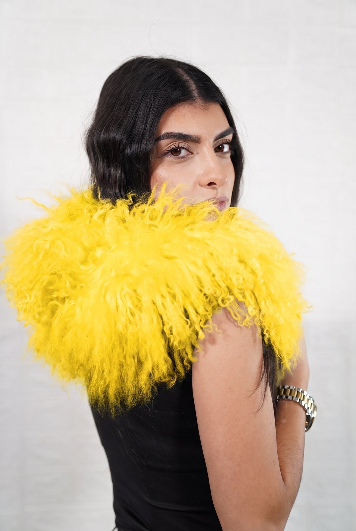 Mongolian Sheepskin Collar Yellow — Curly Lamb Fur side view showing the length of the warm sunflower yellow Mongolian sheepskin collar over the shoulder — Greek craftsmanship, TatiFurs