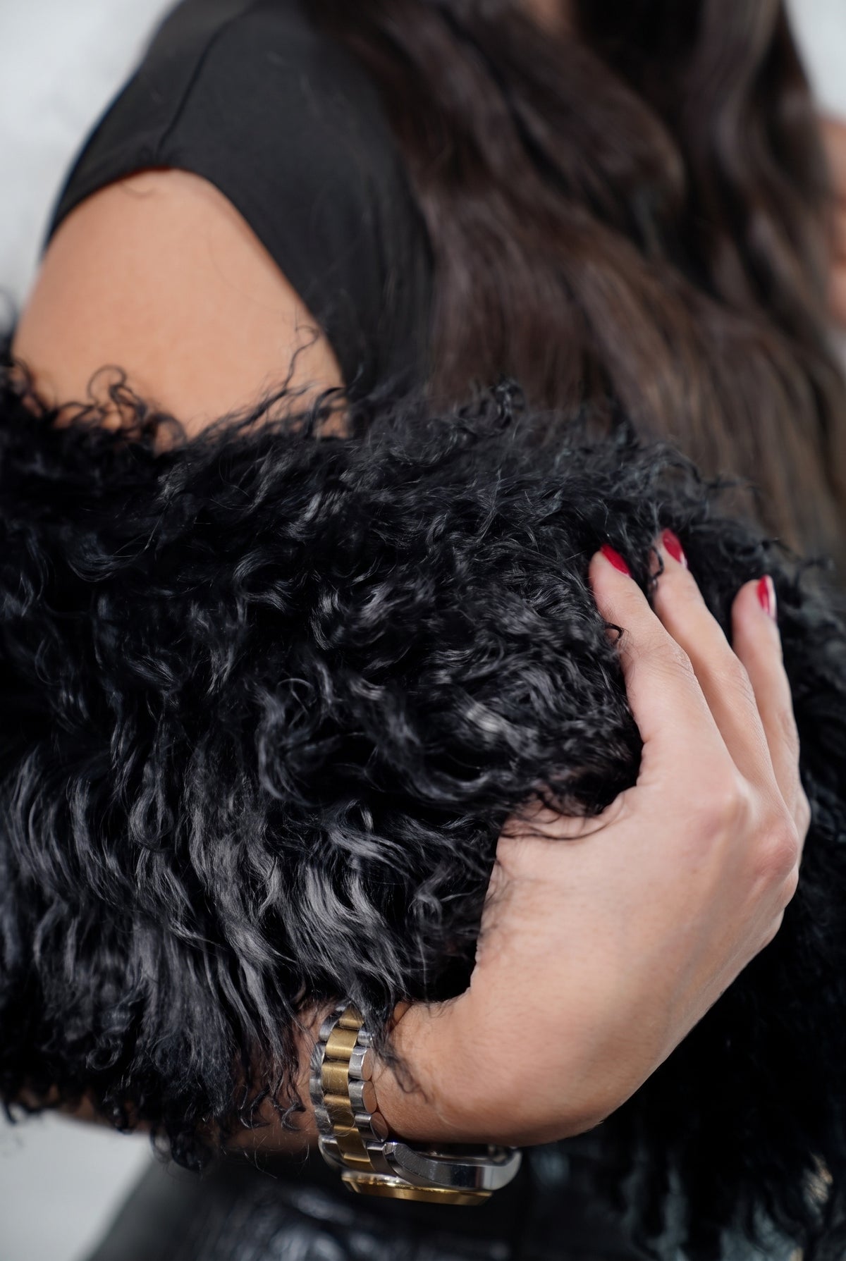 Mongolian Sheepskin Collar Black — Curly Lamb Fur close-up of the dense deep jet black Tibetan lamb curls held in the hand — TatiFurs