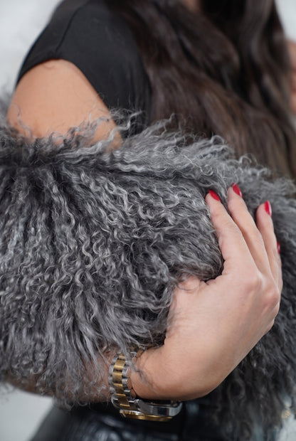 Mongolian Sheepskin Collar Grey — Curly Lamb Fur close-up of the dense smoky charcoal grey Tibetan lamb curls held in the hand — TatiFurs