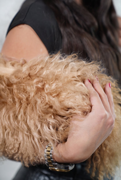 Mongolian Sheepskin Collar Light Brown — Curly Lamb Fur close-up of the dense milky caramel light brown Tibetan lamb curls held in the hand — TatiFurs