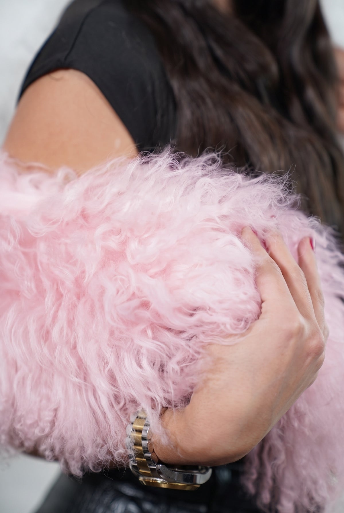 Mongolian Sheepskin Collar Pink — Curly Lamb Fur close-up of the dense pale powder pink Tibetan lamb curls held in the hand — TatiFurs