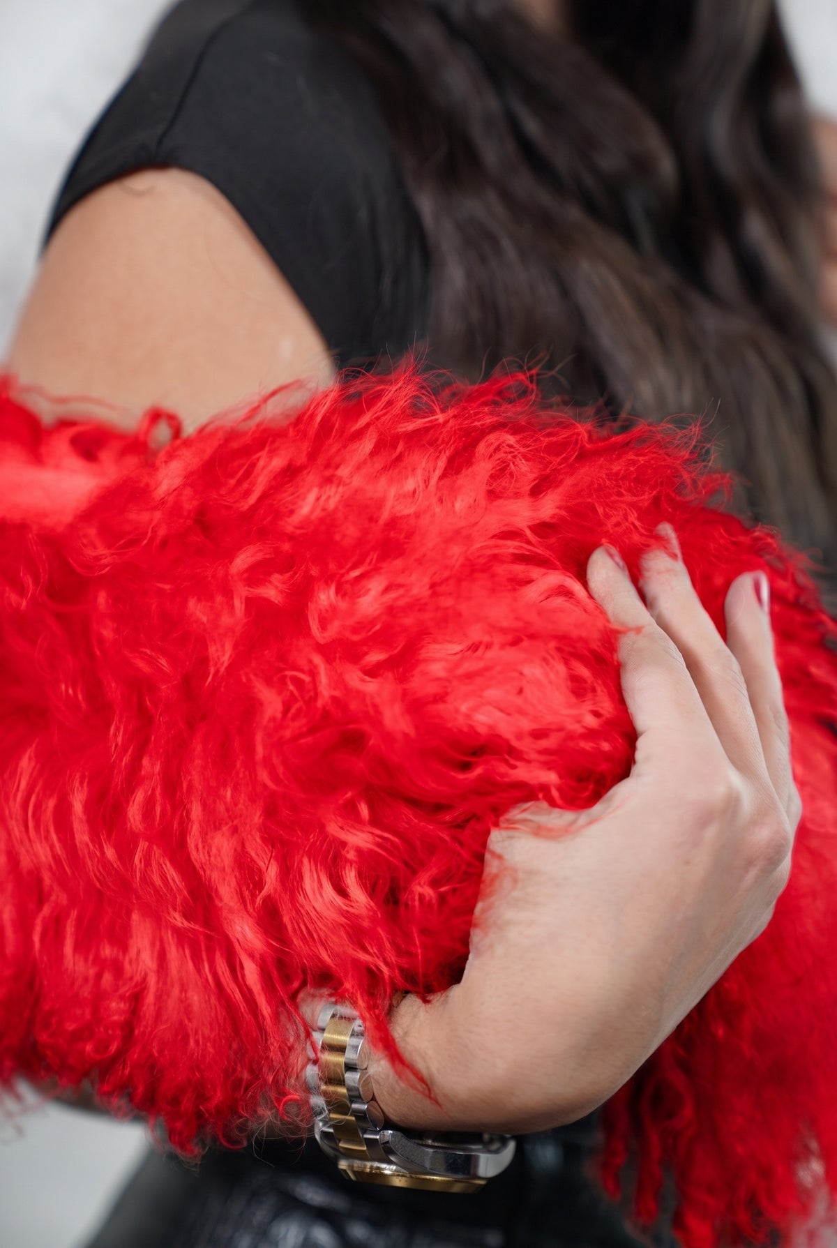 Mongolian Sheepskin Collar Red — Curly Lamb Fur close-up of the dense vivid scarlet red Tibetan lamb curls held in the hand — TatiFurs
