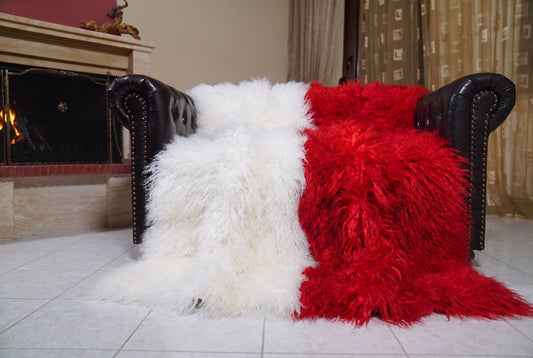 Mongolian Blanket Throw White Red Two Tone — Wool Sheepskin spread across the leather sofa showing the whole pure white and scarlet red Mongolian wool surface — Greek craftsmanship, TatiFurs