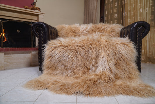 Mongolian Blanket Throw Camel — Wool Sheepskin Full Skin spread across the leather sofa showing the whole warm golden camel Mongolian wool surface — Greek craftsmanship, TatiFurs