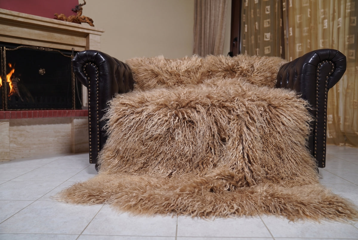 Mongolian Blanket Throw Light Brown — Wool Sheepskin Full Skin spread across the leather sofa showing the whole milky caramel light brown Mongolian wool surface — Greek craftsmanship, TatiFurs