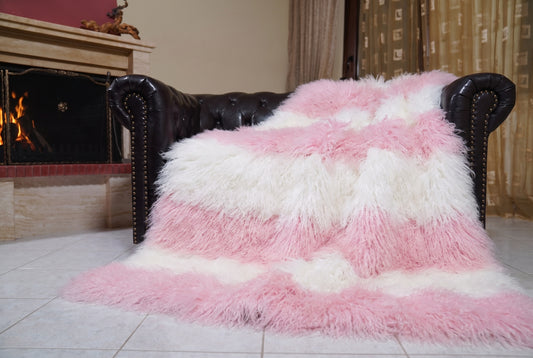 Mongolian Blanket Throw Pink White Striped — Wool Sheepskin spread across the leather sofa showing the whole powder pink and pure white Mongolian wool surface — Greek craftsmanship, TatiFurs