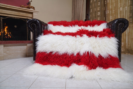 Mongolian Blanket Throw White Red Striped — Wool Sheepskin spread across the leather sofa showing the whole pure white and scarlet red Mongolian wool surface — Greek craftsmanship, TatiFurs
