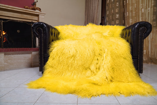Mongolian Blanket Throw Yellow — Wool Sheepskin Full Skin spread across the leather sofa showing the whole bright sunny yellow Mongolian wool surface — Greek craftsmanship, TatiFurs