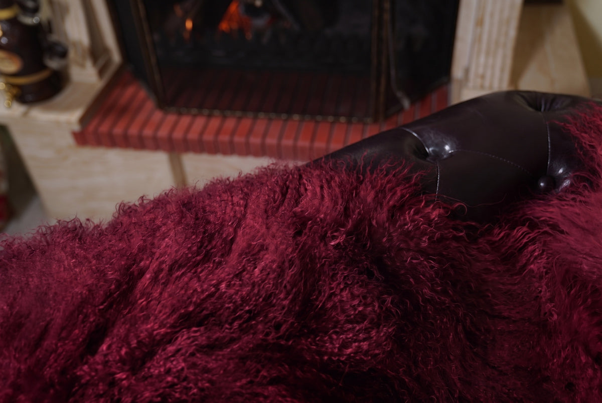 Mongolian Blanket Throw Burgundy — Wool Sheepskin Full Skin close-up texture of the long curly deep oxblood burgundy Mongolian lamb wool pile — Greek craftsmanship, TatiFurs