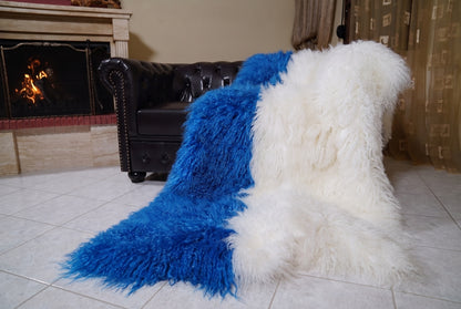 Mongolian Blanket Throw Blue White Two Tone — Wool Sheepskin draped from the sofa towards the fireplace showing how the cobalt blue and pure white long wool falls — TatiFurs