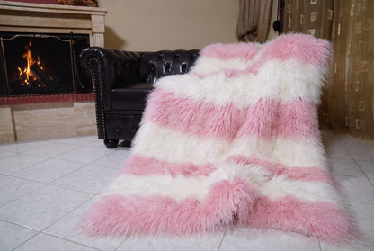 Mongolian Blanket Throw Pink White Striped — Wool Sheepskin draped from the sofa towards the fireplace showing how the powder pink and pure white long wool falls — TatiFurs
