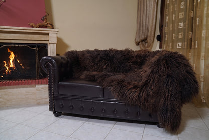 Mongolian Blanket Throw Dark Brown — Wool Sheepskin Full Skin hanging from the sofa down to the travertine floor — deep espresso dark brown Mongolian sheepskin throw, TatiFurs