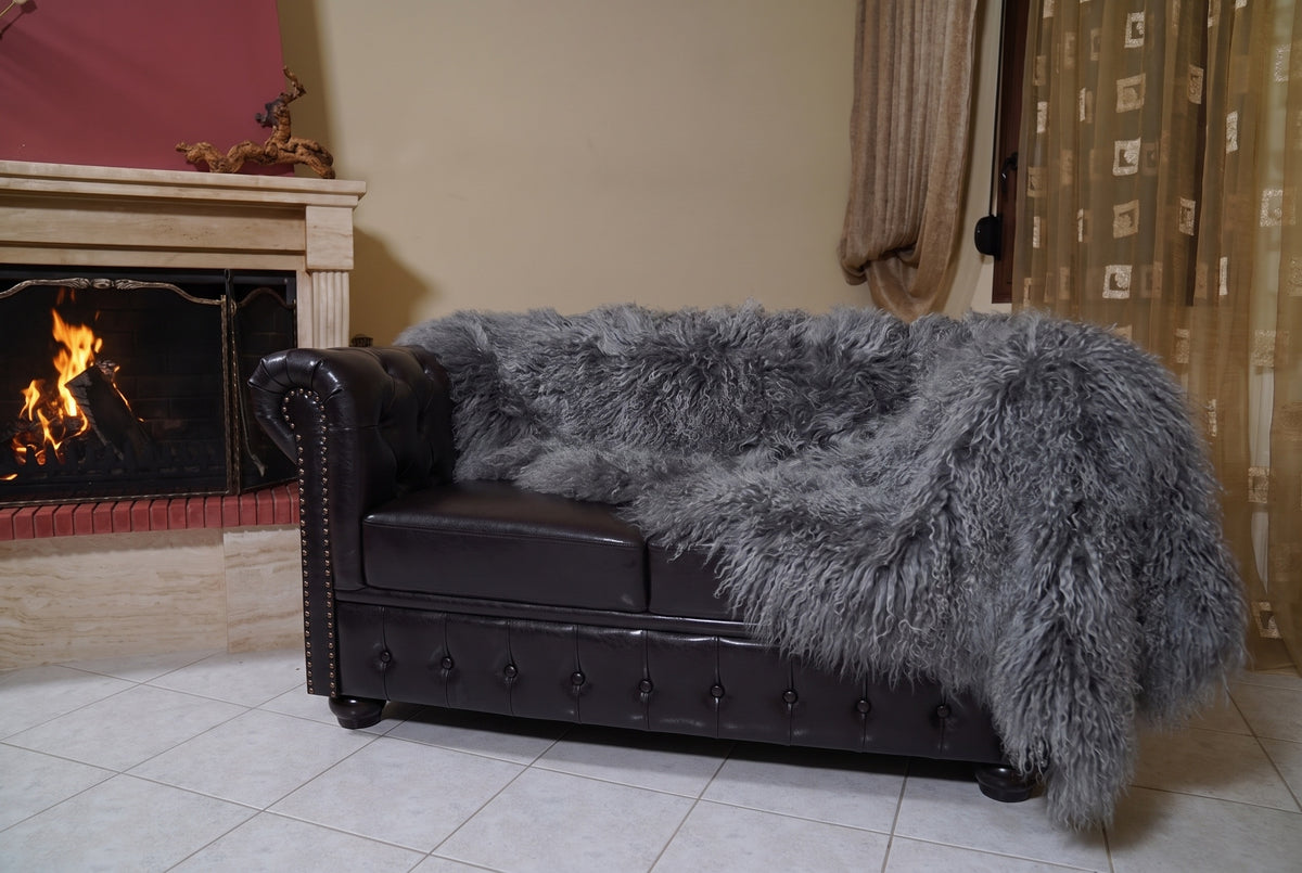 Mongolian Blanket Throw Gray — Wool Sheepskin Full Skin hanging from the sofa down to the travertine floor — grey Mongolian sheepskin throw, TatiFurs