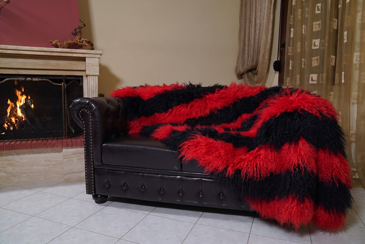 Mongolian Blanket Throw Red Black Striped — Wool Sheepskin hanging from the sofa down to the travertine floor — scarlet red and jet black Mongolian sheepskin throw, TatiFurs