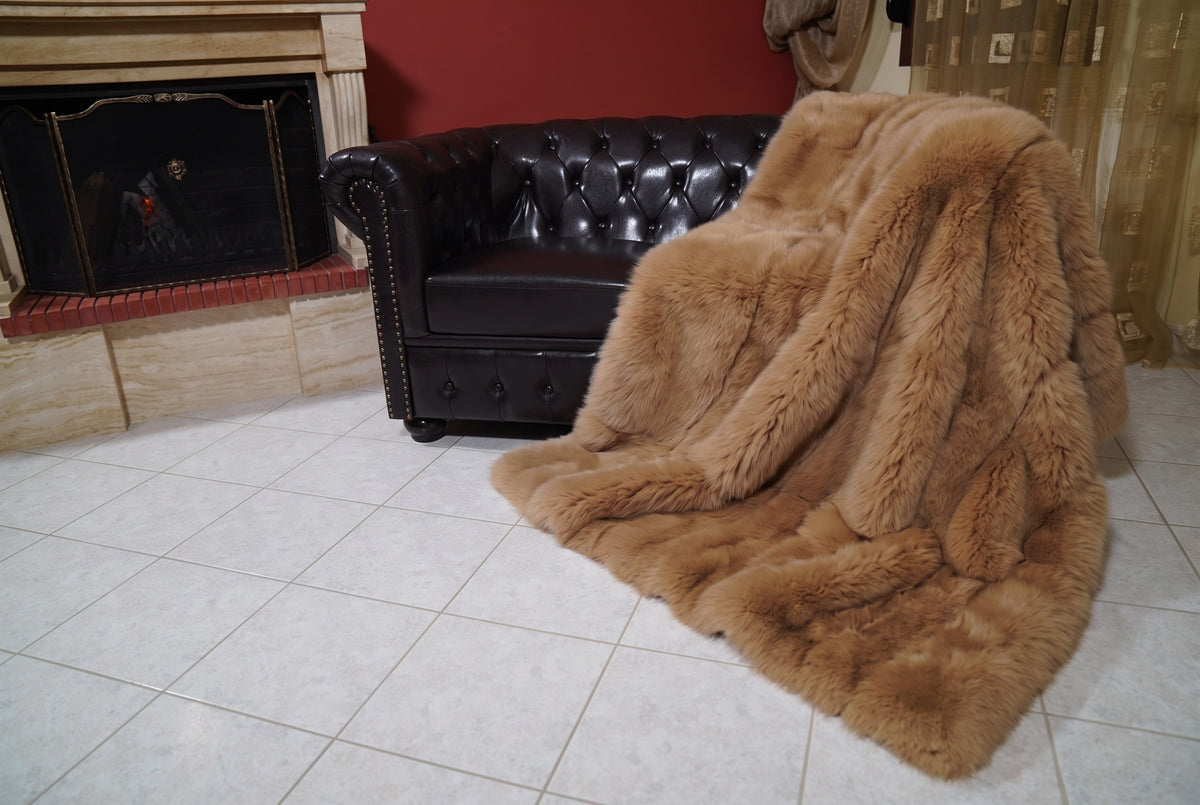 Fox Fur Blanket Throw Camel Brown — Full Skin Saga Furs spilling from the armchair onto the tiled floor — the warm golden camel brown full skin fox fur catching the light, TatiFurs