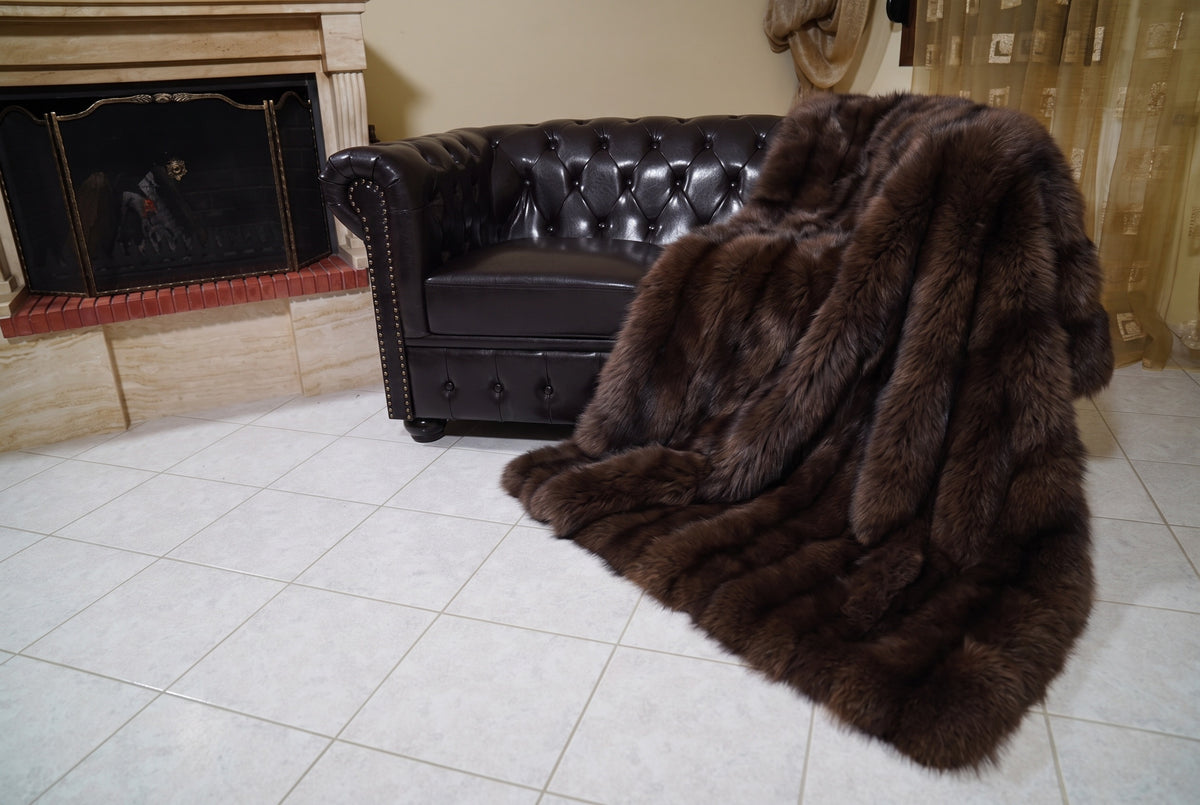 Fox Fur Blanket Throw Dark Brown — Full Skin Saga Furs spilling from the armchair onto the tiled floor — the deep chocolate brown full skin fox fur catching the light, TatiFurs