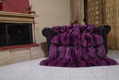 Fox Fur Blanket Throw Purple Silver — Full Skin Saga Furs draped over a dark brown leather Chesterfield armchair beside the fireplace — full view of the purple-tipped silver full skin fox pelts, TatiFurs