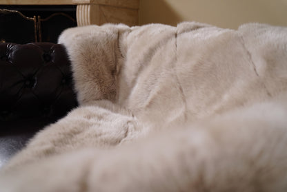 Fox Fur Blanket Throw Beige — Full Skin Saga Furs close-up of the dense warm sand beige fox fur texture at the edge of the armchair — Saga Furs quality, TatiFurs