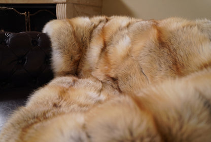 Fox Fur Blanket Throw Golden Island — Full Skin Saga Furs close-up of the dense honey-gold Golden Island fox fur texture at the edge of the armchair — Saga Furs quality, TatiFurs