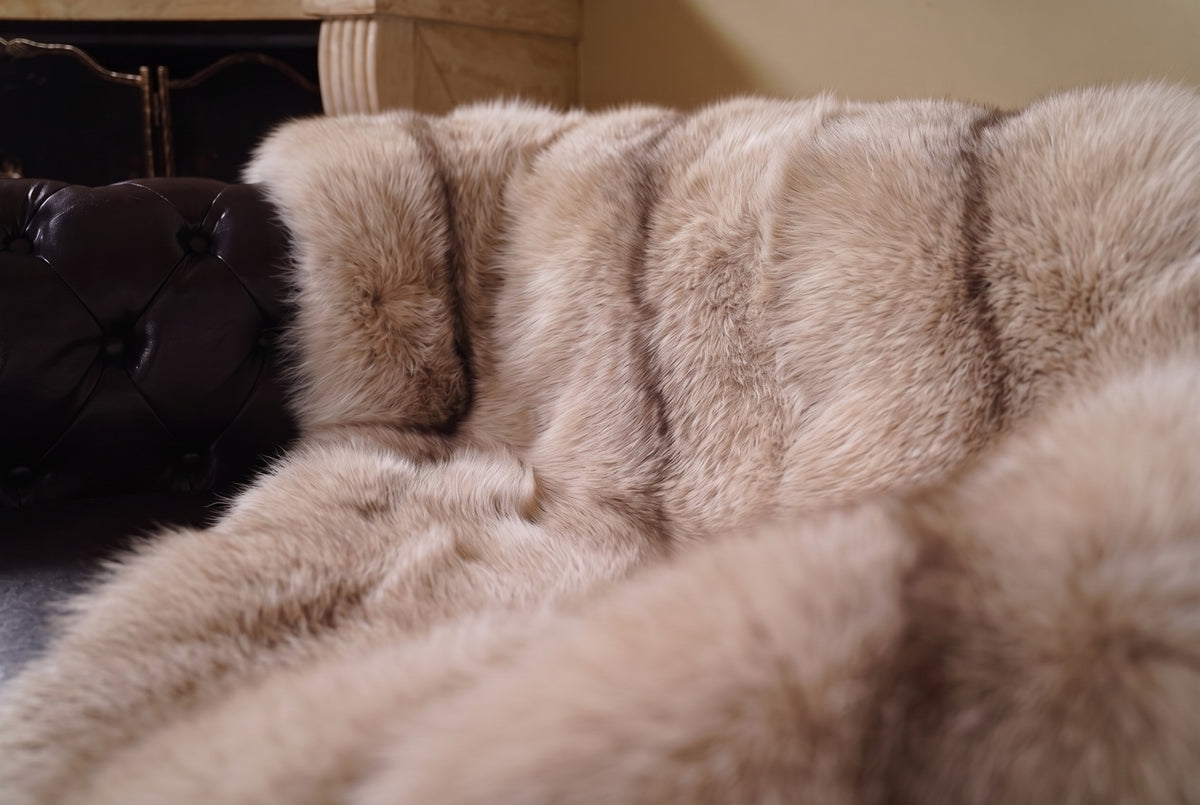 Fox Fur Blanket Throw Palomino Frost — Full Skin Saga Furs close-up of the dense sand and brown Palomino Frost fox fur texture at the edge of the armchair — Saga Furs quality, TatiFurs