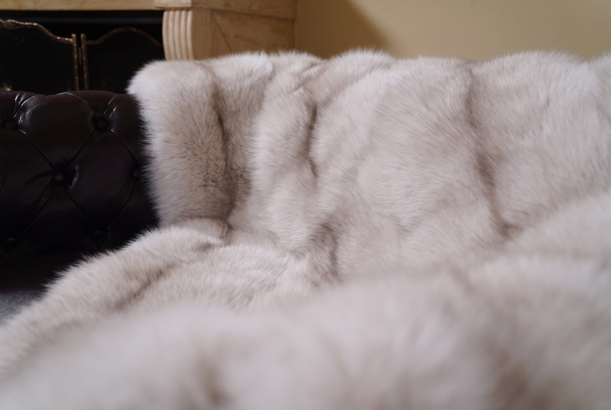 Fox Fur Blanket Throw Pastel Frost — Full Skin Saga Furs close-up of the dense soft greige with a taupe line fox fur texture at the edge of the armchair — Saga Furs quality, TatiFurs