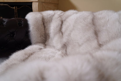 Fox Fur Blanket Throw Pastel Frost — Full Skin Saga Furs close-up of the dense soft greige with a taupe line fox fur texture at the edge of the armchair — Saga Furs quality, TatiFurs