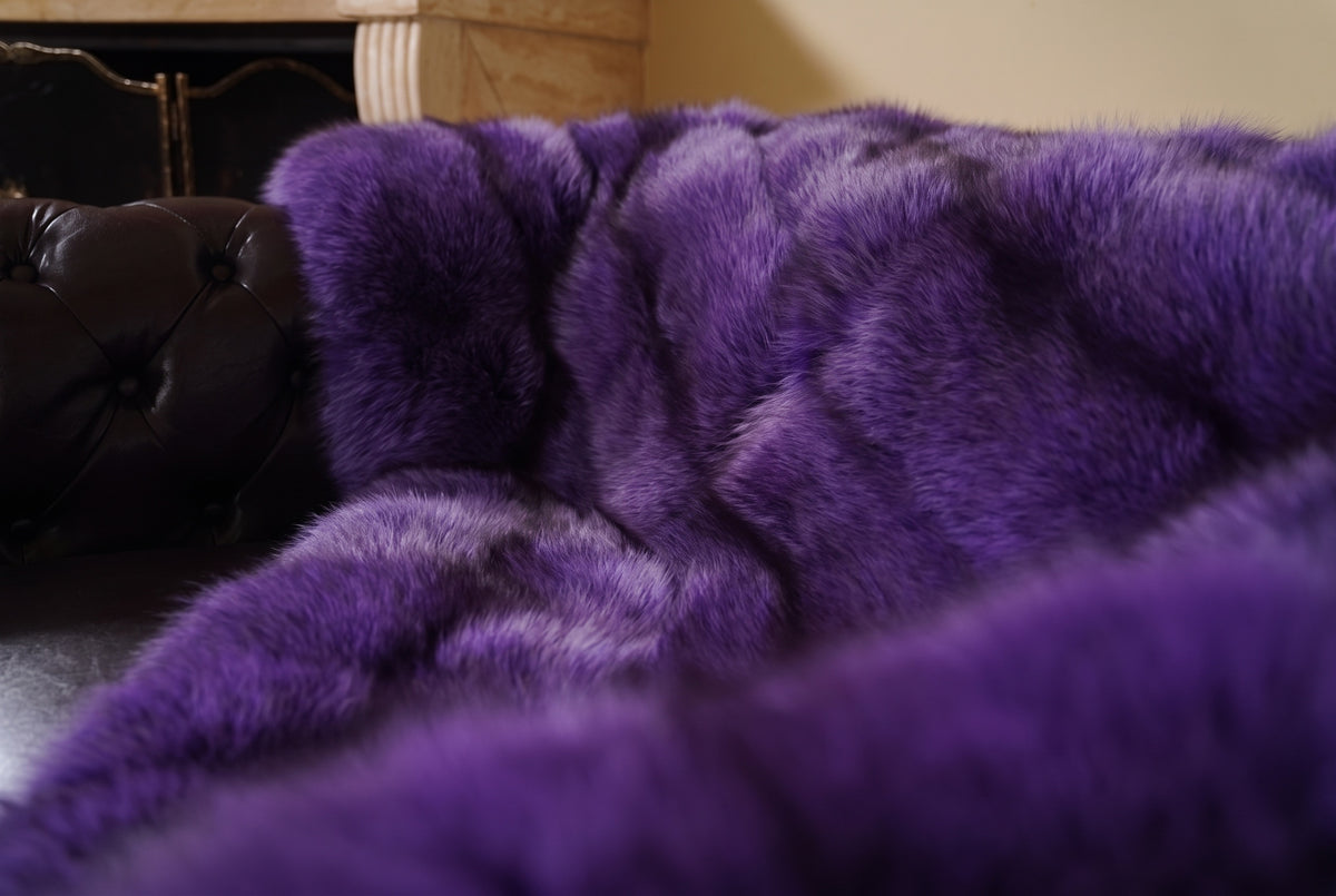 Fox Fur Blanket Throw Purple — Full Skin Saga Furs close-up of the dense rich violet purple fox fur texture at the edge of the armchair — Saga Furs quality, TatiFurs