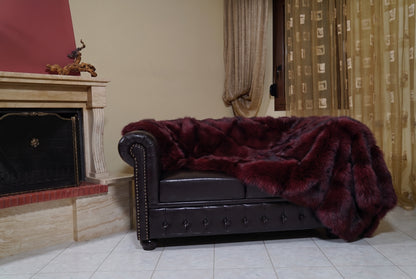 Fox Fur Blanket Throw Red Burgundy — Full Skin Saga Furs on the leather armchair in a fireplace living room with curtains — deep wine burgundy real fox fur throw, TatiFurs