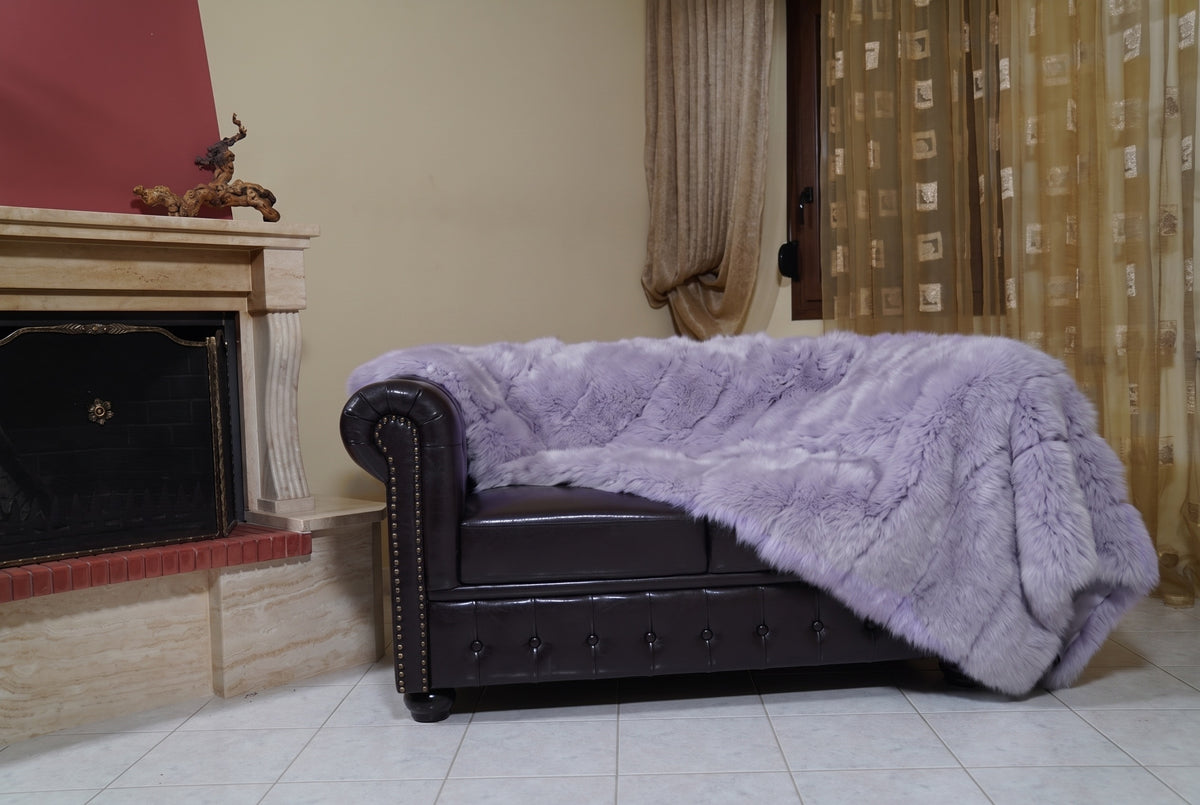 Fox Fur Blanket Throw Lavender Purple — Full Skin Saga Furs on the leather armchair in a fireplace living room with curtains — soft lavender purple real fox fur throw, TatiFurs