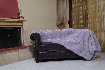 Fox Fur Blanket Throw Lavender Purple — Full Skin Saga Furs on the leather armchair in a fireplace living room with curtains — soft lavender purple real fox fur throw, TatiFurs
