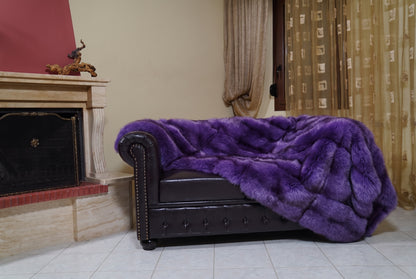 Fox Fur Blanket Throw Purple — Full Skin Saga Furs on the leather armchair in a fireplace living room with curtains — rich violet purple real fox fur throw, TatiFurs