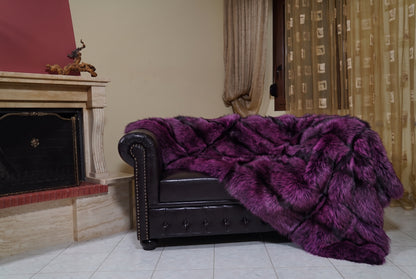 Fox Fur Blanket Throw Purple Silver — Full Skin Saga Furs on the leather armchair in a fireplace living room with curtains — purple-tipped silver real fox fur throw, TatiFurs