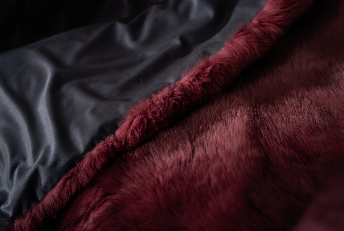 Fox Fur Blanket Throw Red Burgundy — Full Skin Saga Furs edge turned over to show the soft lining behind the deep wine burgundy full skin fox fur — TatiFurs