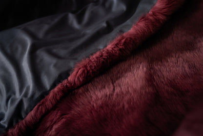 Fox Fur Blanket Throw Red Burgundy — Full Skin Saga Furs edge turned over to show the soft lining behind the deep wine burgundy full skin fox fur — TatiFurs