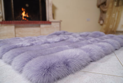 Fox Fur Blanket Throw Lavender Purple — Full Skin Saga Furs laid flat on the floor in front of the lit fireplace, low angle showing the soft lavender purple fox pelt rows, TatiFurs
