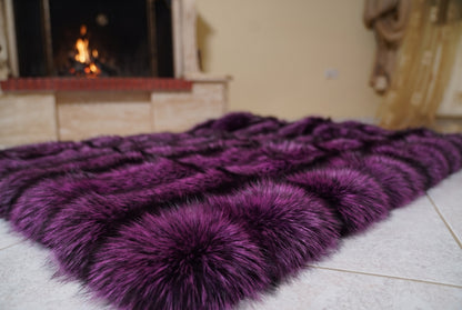Fox Fur Blanket Throw Purple Silver — Full Skin Saga Furs laid flat on the floor in front of the lit fireplace, low angle showing the purple-tipped silver fox pelt rows, TatiFurs