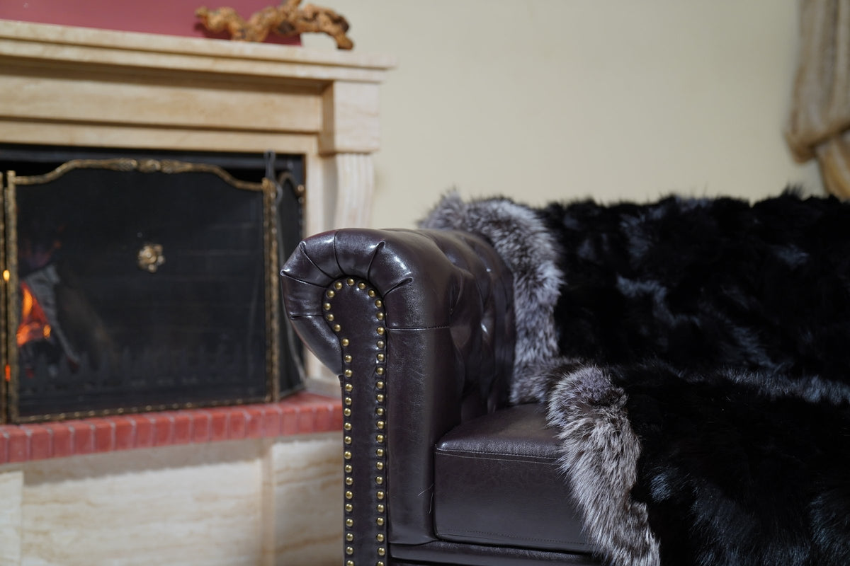 fox fur blanket throw black silver borders — detail over the sofa arm, black fox fur with silver fox border trim — Greek craftsmanship, TatiFurs
