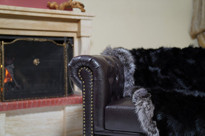 fox fur blanket throw black silver borders — detail over the sofa arm, black fox fur with silver fox border trim — Greek craftsmanship, TatiFurs