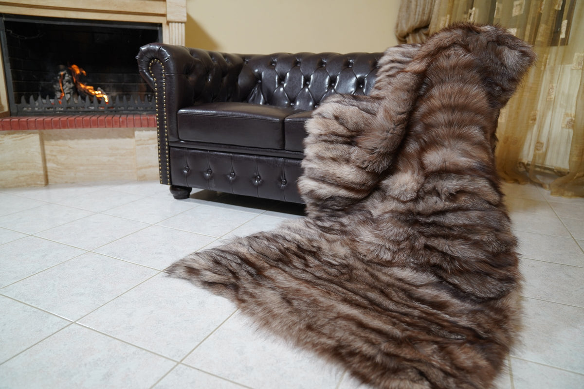 fox fur blanket throw crystal natural striped — full view draped from a Chesterfield sofa to the floor, rows of natural crystal fox in brown, silver and black — TatiFurs