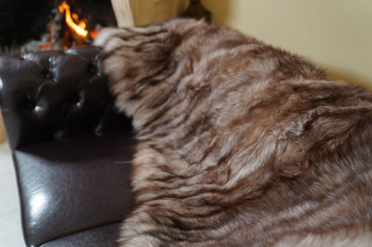 fox fur blanket throw double sided crystal natural striped — detail over the sofa arm, brown and silver crystal fox stripes — TatiFurs